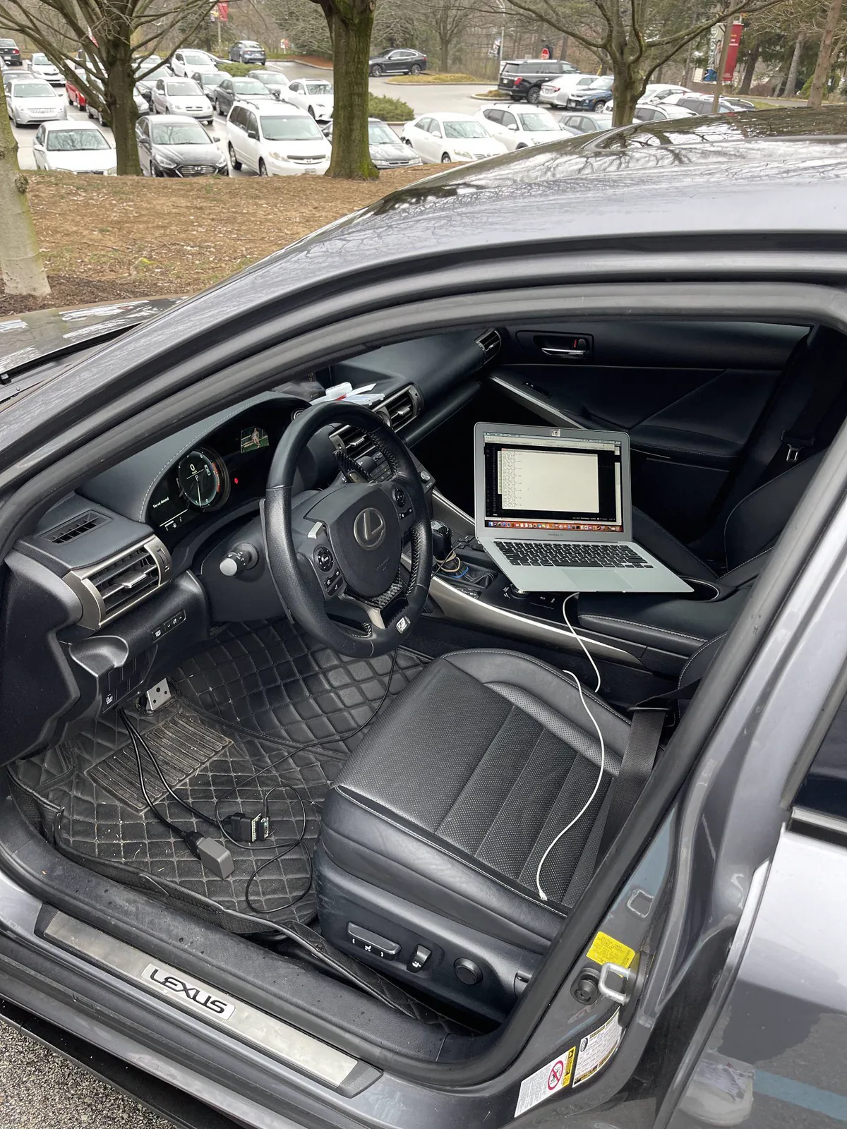 Lexus capstone setup with a laptop, cabling, and OBD hardware
